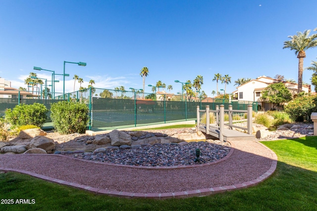 view of home's community featuring fence