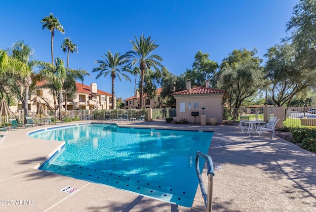 pool with fence and a patio