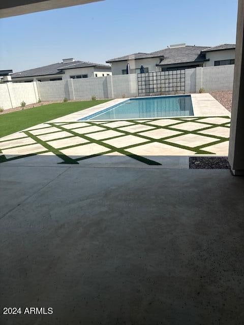 view of swimming pool featuring a patio area