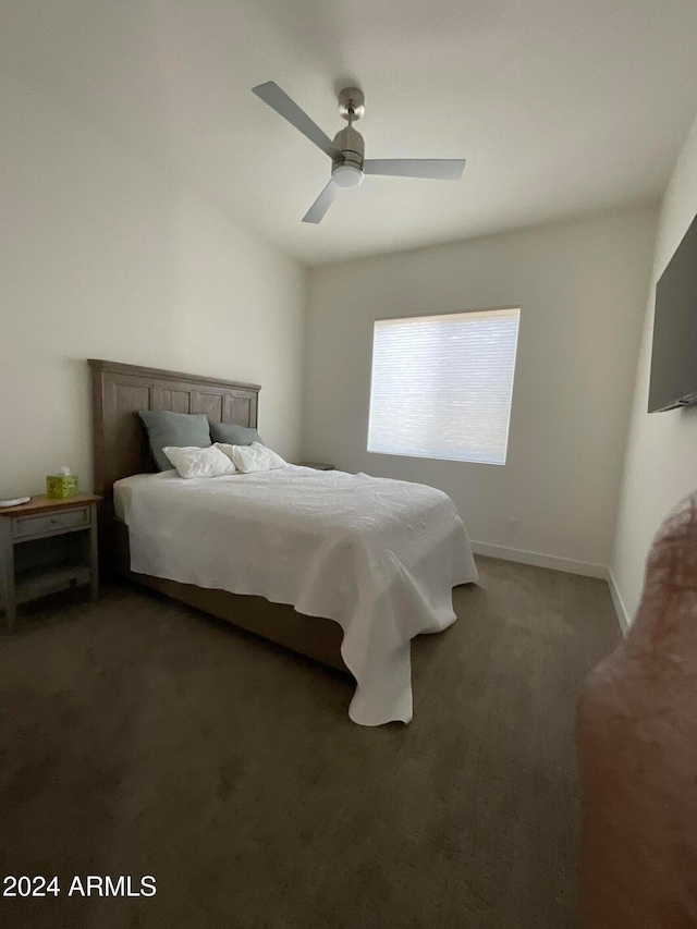 bedroom with ceiling fan and dark colored carpet