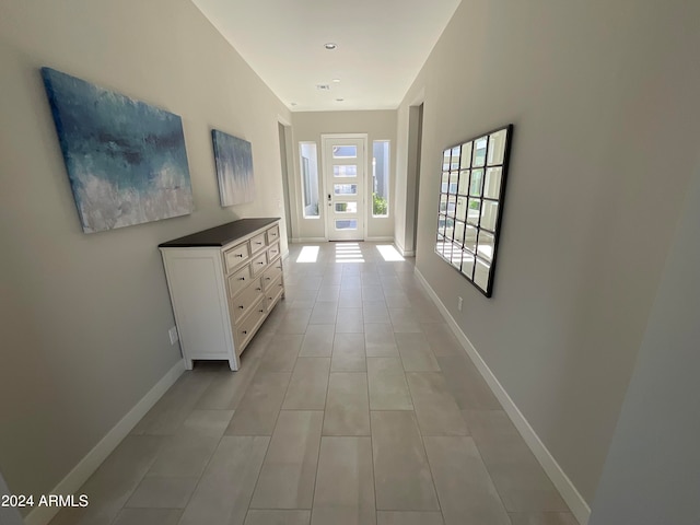 hall with light tile patterned floors