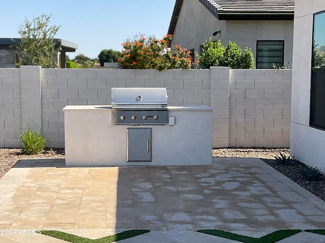 view of patio / terrace with area for grilling and a grill