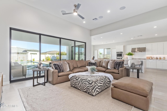 tiled living room featuring a high ceiling