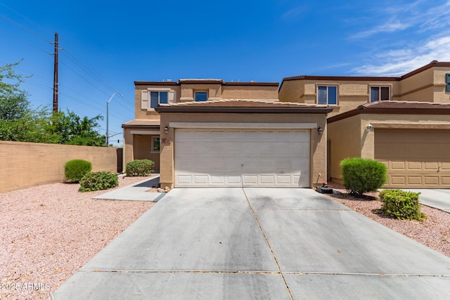 2565 E Southern Ave Unit 130, Mesa, AZ 85204 - view of front of property with concrete driveway, stucco siding, and a garage