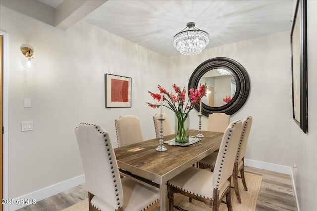 dining room featuring a chandelier and light hardwood / wood-style flooring