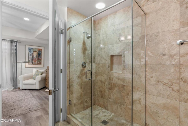 bathroom featuring hardwood / wood-style flooring and a shower with door