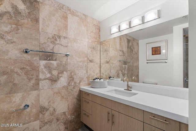 bathroom featuring vanity, toilet, and tile walls