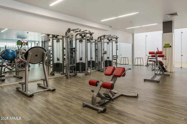 workout area with hardwood / wood-style floors