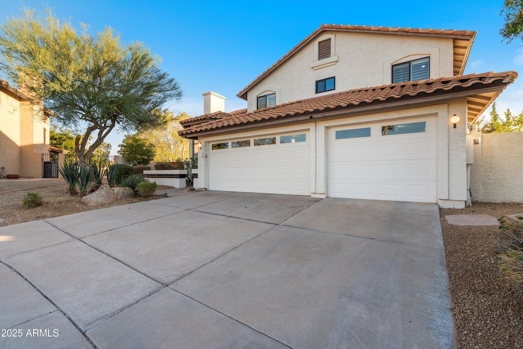 view of front of house with central AC and a garage