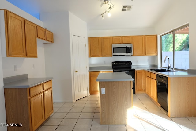 kitchen with sink, a kitchen island, black appliances, and light tile patterned floors