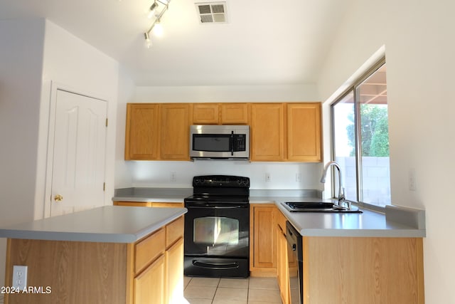 kitchen featuring black appliances, light tile patterned flooring, a kitchen island, and sink