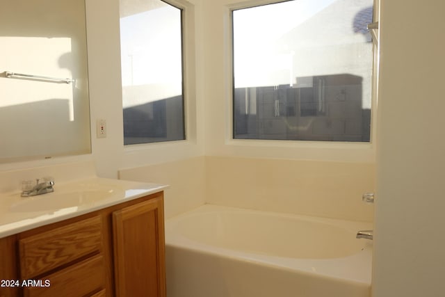 bathroom featuring a tub and vanity