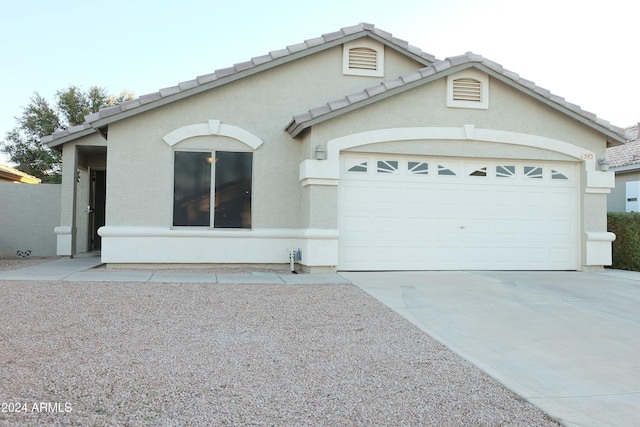 ranch-style home featuring a garage