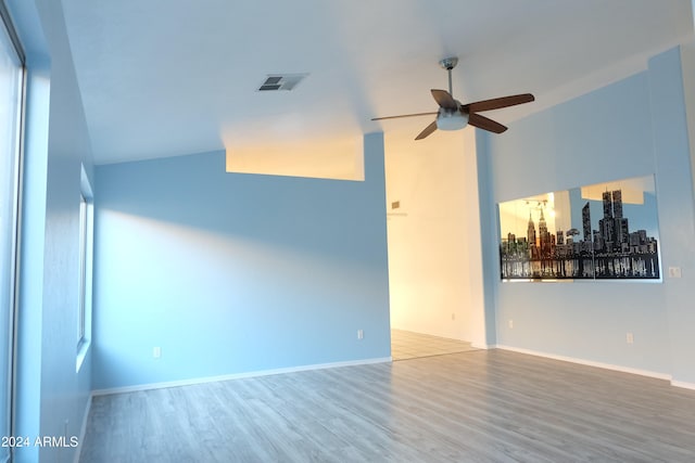 spare room with hardwood / wood-style floors, ceiling fan, and lofted ceiling