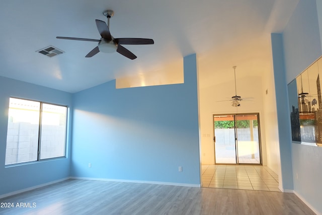 spare room with ceiling fan, light hardwood / wood-style floors, and lofted ceiling