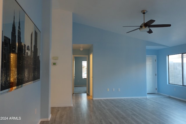 spare room featuring ceiling fan, light hardwood / wood-style floors, and lofted ceiling