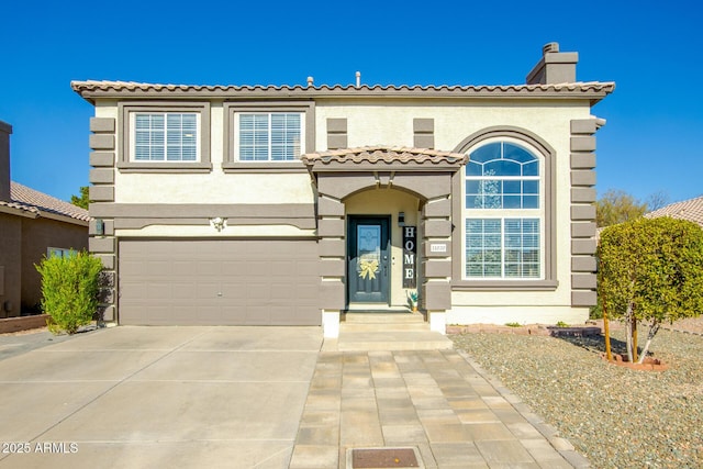 mediterranean / spanish house with a garage