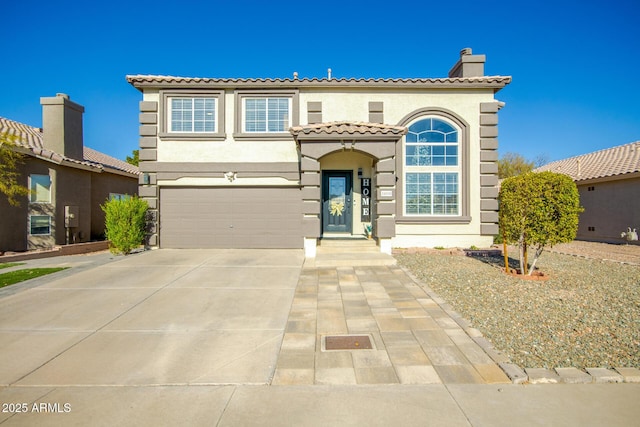 mediterranean / spanish house featuring a garage