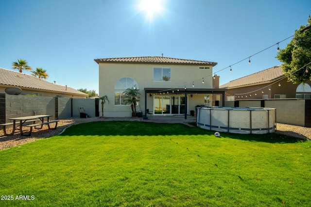 back of house featuring a yard