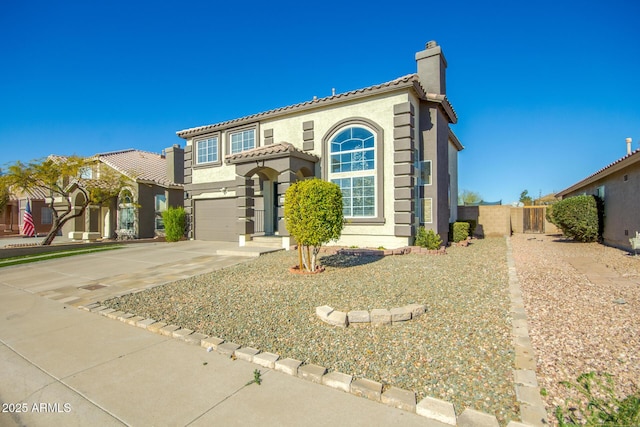 mediterranean / spanish-style home with a garage