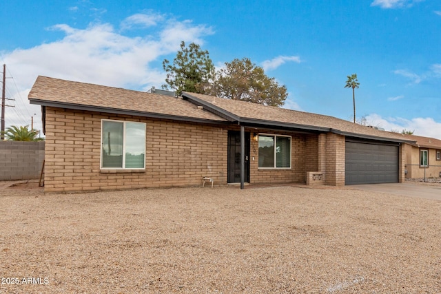 ranch-style house with brick siding, an attached garage, and driveway