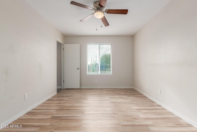 unfurnished room with baseboards, light wood-style floors, and ceiling fan