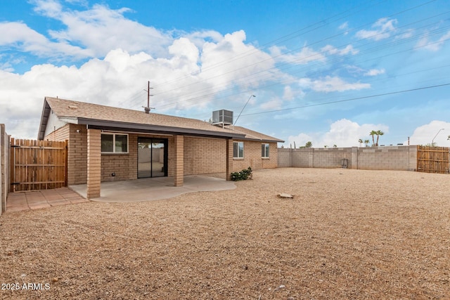 back of property with a patio area, central AC unit, and a fenced backyard