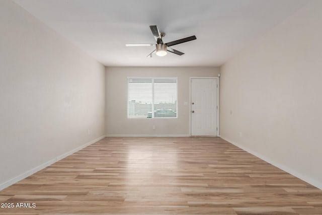 empty room with light wood-style flooring, baseboards, and ceiling fan