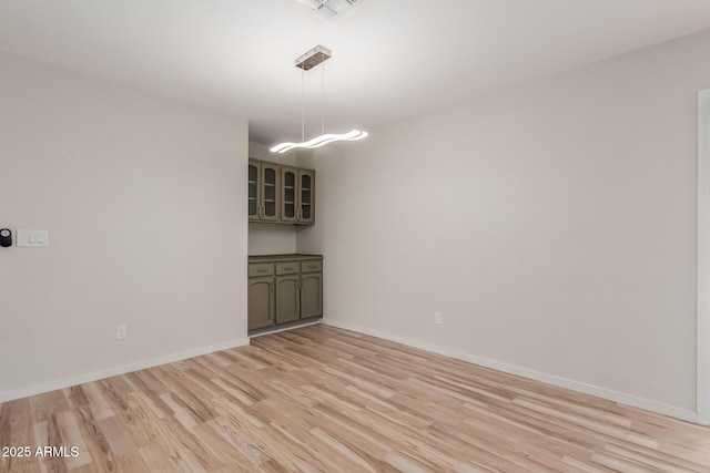 unfurnished dining area with visible vents, baseboards, and light wood finished floors