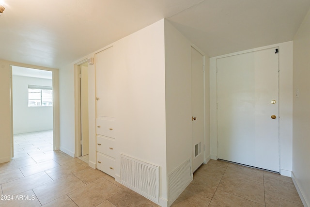 corridor featuring light tile patterned floors