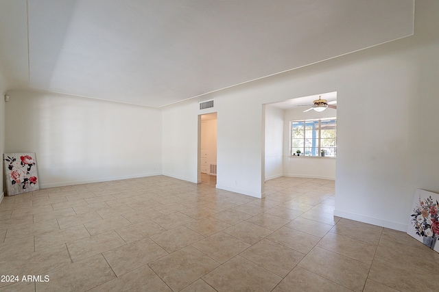 unfurnished room with light tile patterned flooring and ceiling fan