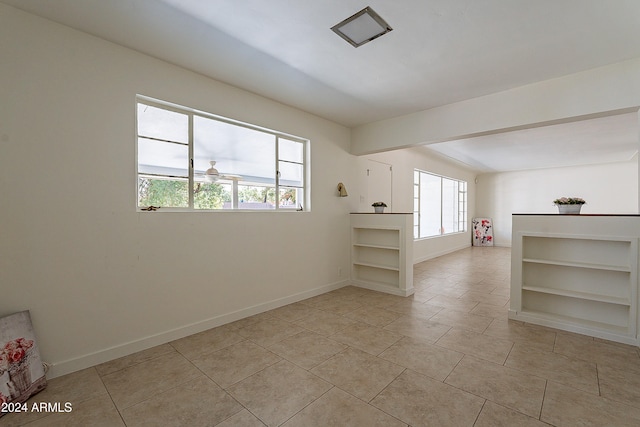 bonus room featuring light tile patterned flooring and ceiling fan