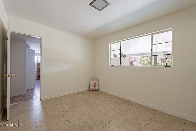 unfurnished room featuring light tile patterned floors