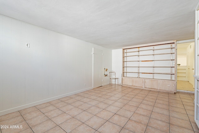 unfurnished room with light tile patterned floors