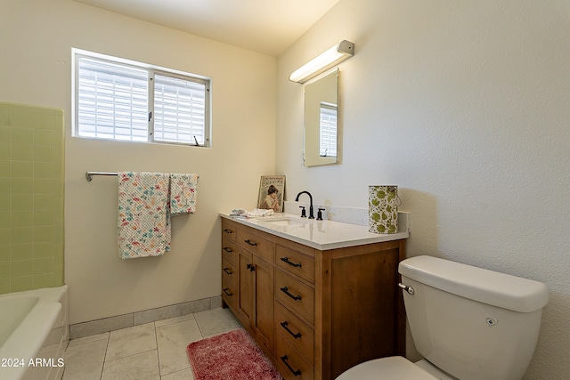 bathroom with toilet, vanity, and tile patterned floors