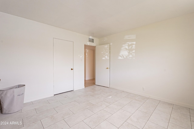 empty room with light tile patterned floors