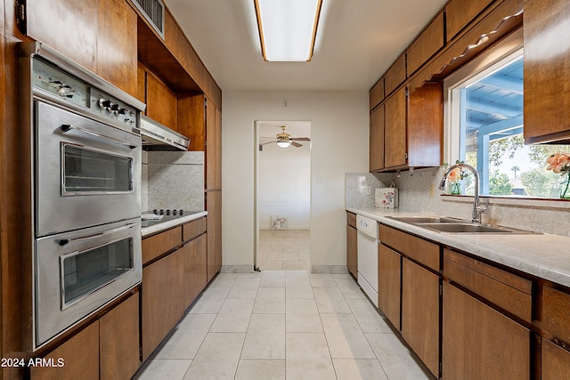 kitchen featuring backsplash, extractor fan, white dishwasher, sink, and double oven