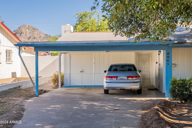 view of outdoor structure with a mountain view and a carport