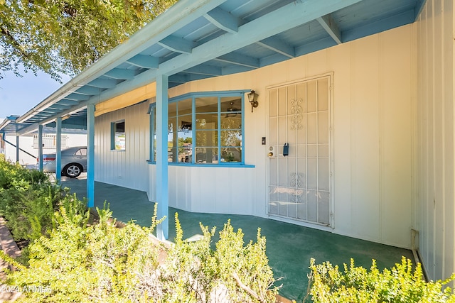 view of exterior entry with a carport