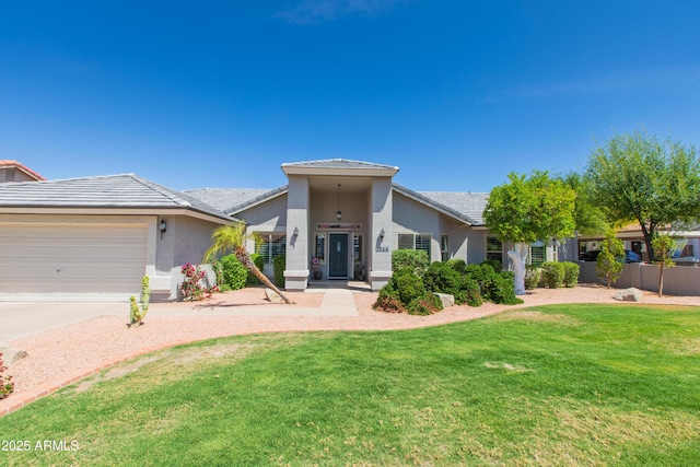 view of front of house featuring a front lawn, a garage, driveway, a tiled roof, and stucco siding