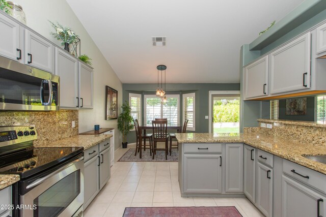 kitchen with light tile patterned floors, visible vents, stainless steel appliances, and decorative backsplash