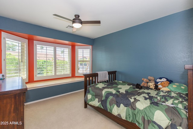 bedroom with carpet, visible vents, baseboards, and multiple windows