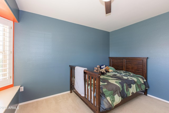carpeted bedroom featuring a ceiling fan and baseboards