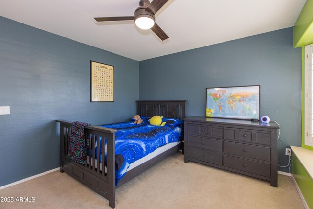 carpeted bedroom featuring baseboards and ceiling fan