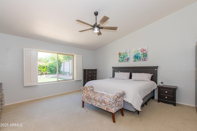 bedroom featuring lofted ceiling, a ceiling fan, light colored carpet, and baseboards