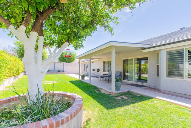 view of yard featuring fence and a patio