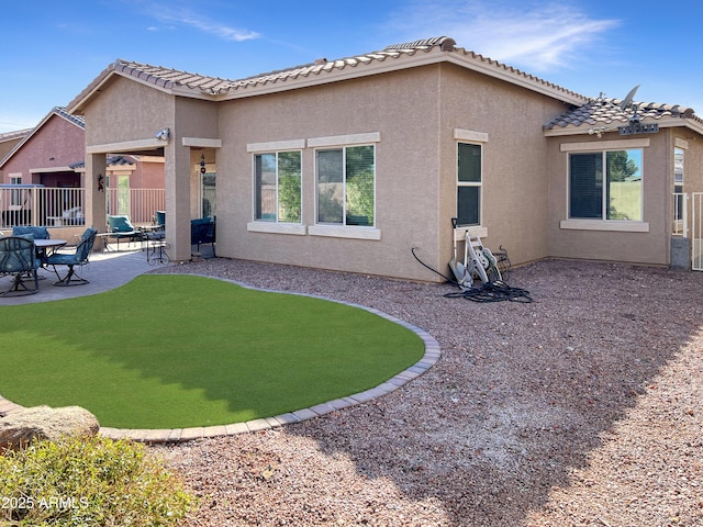 back of property featuring a patio area, fence, and stucco siding