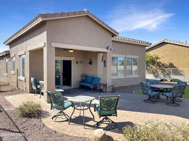 rear view of house with a patio, fence, a ceiling fan, a tiled roof, and stucco siding