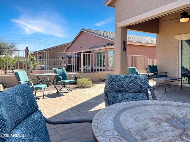 view of patio with ceiling fan, fence, and an outdoor hangout area