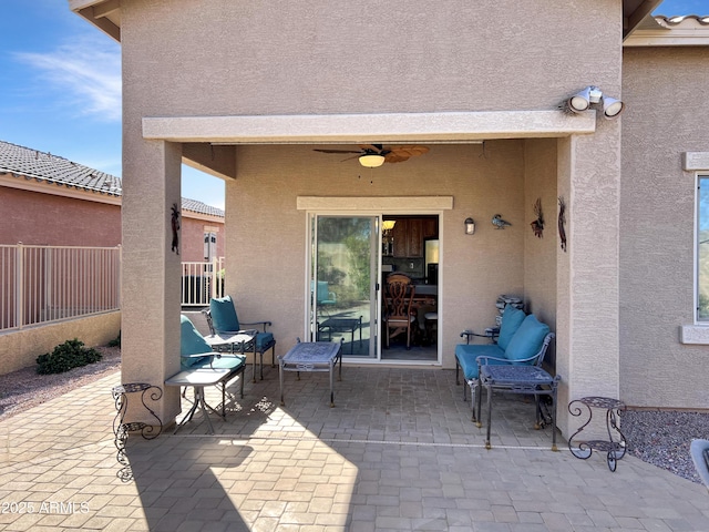 view of patio / terrace with ceiling fan and fence